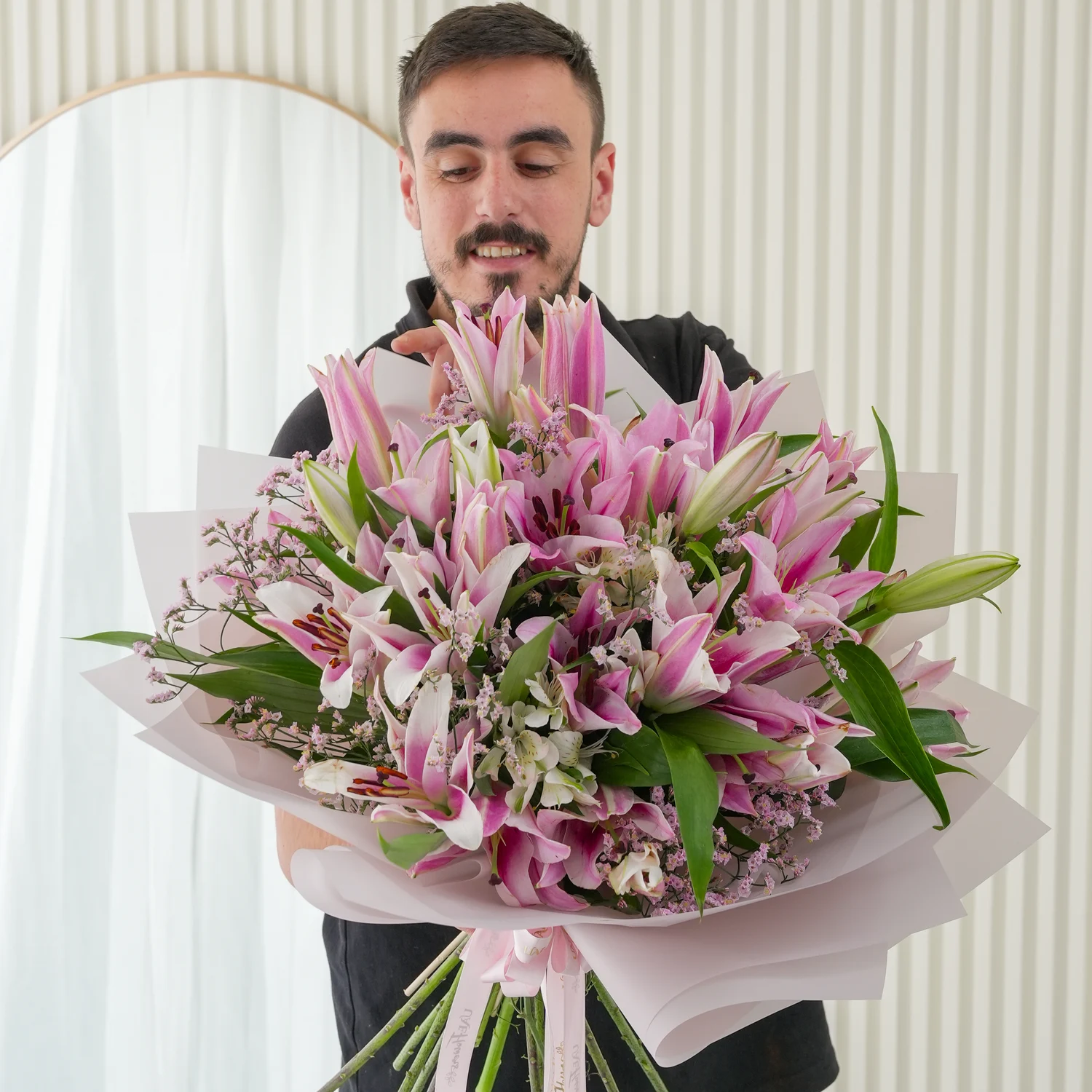Bouquet of 10 pink lilies with green fillers beautifully wrapped in pastel pink wrapping paper.