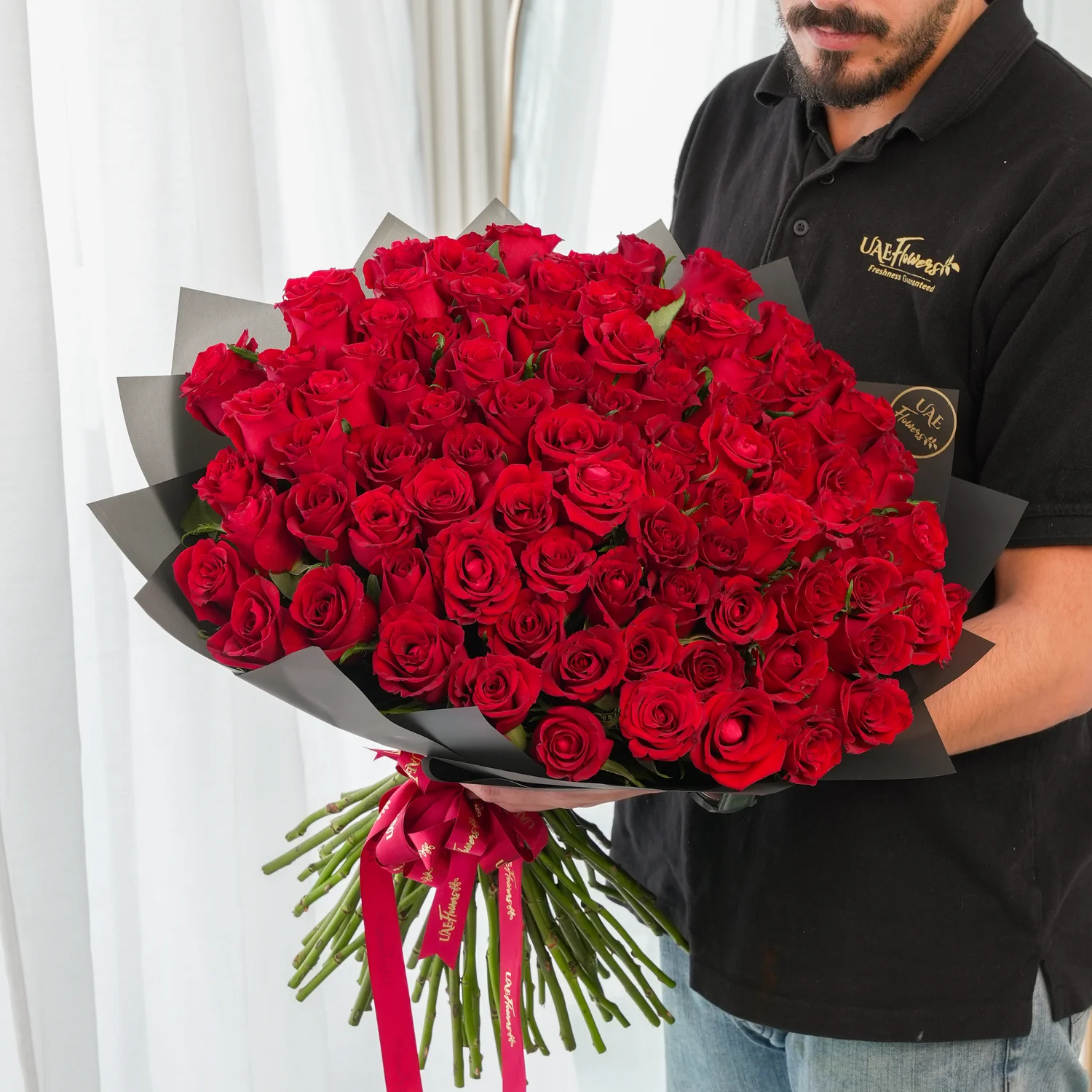 Bouquet of 100 Red Roses hand-tied with a red ribbon