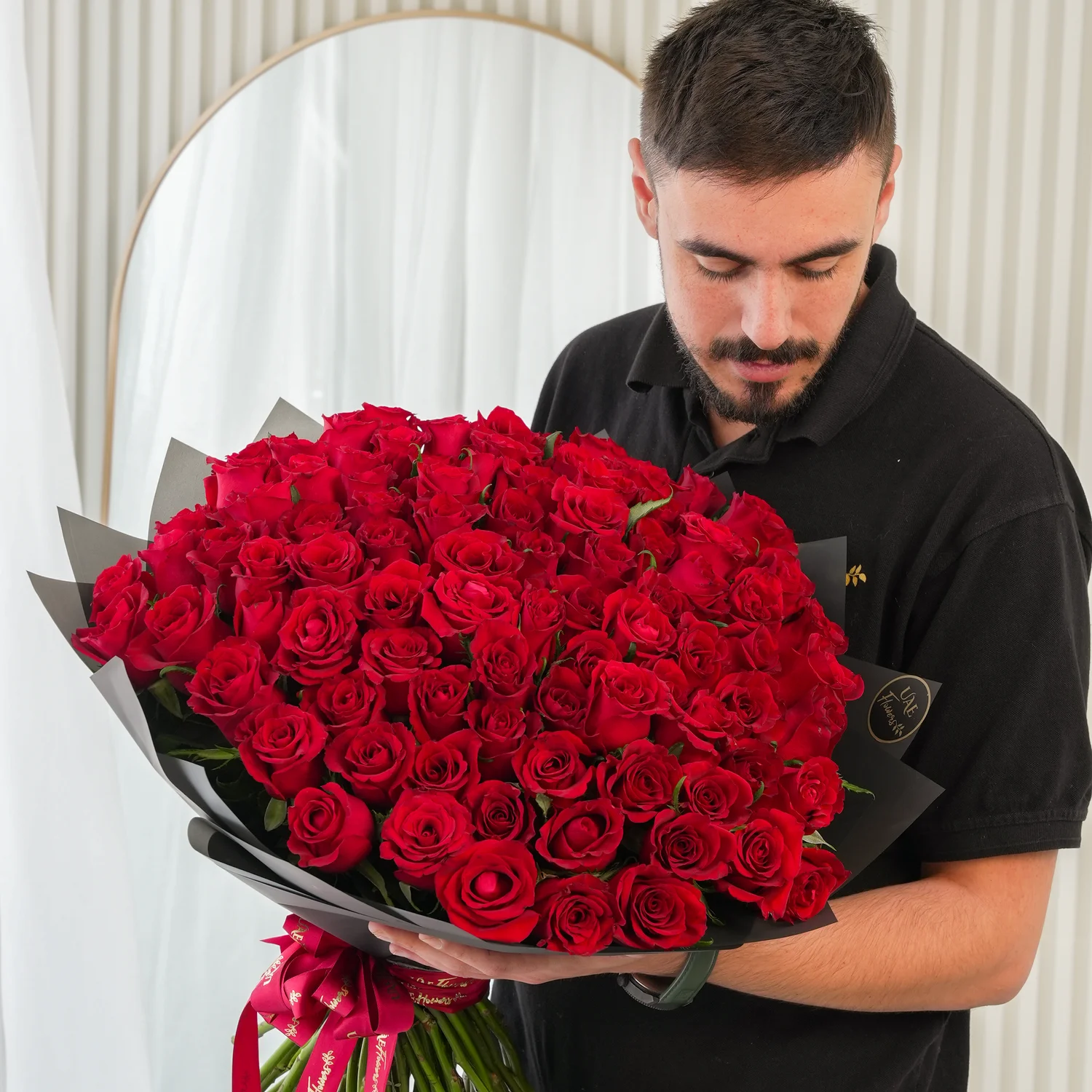 Bouquet of 100 Red Roses hand-tied with a red ribbon