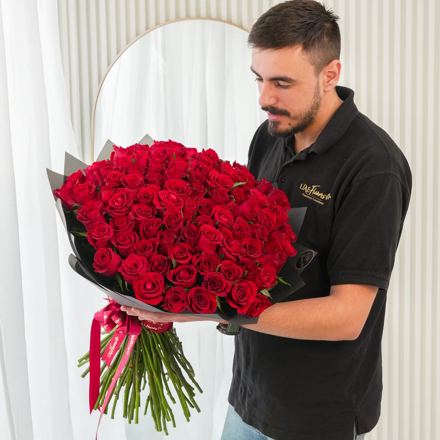 Bouquet of 100 Red Roses hand-tied with a red ribbon