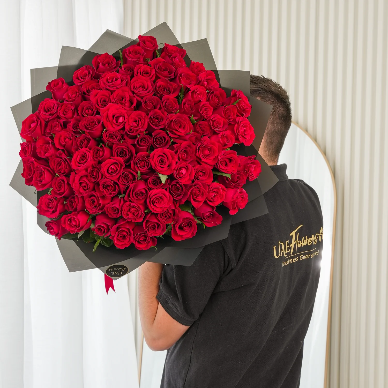 Bouquet of 100 Red Roses hand-tied with a red ribbon