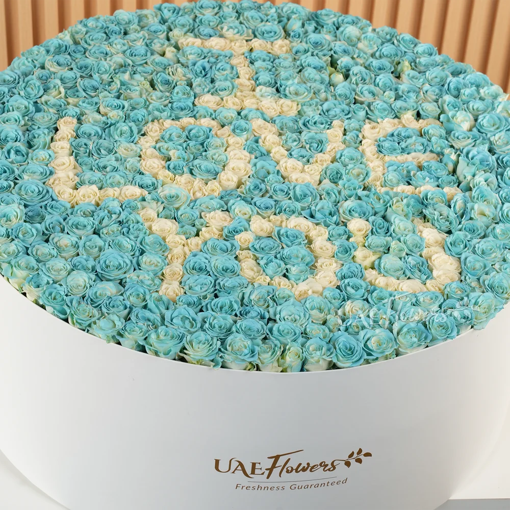 A box arrangement of 150 blue and white roses & spray roses