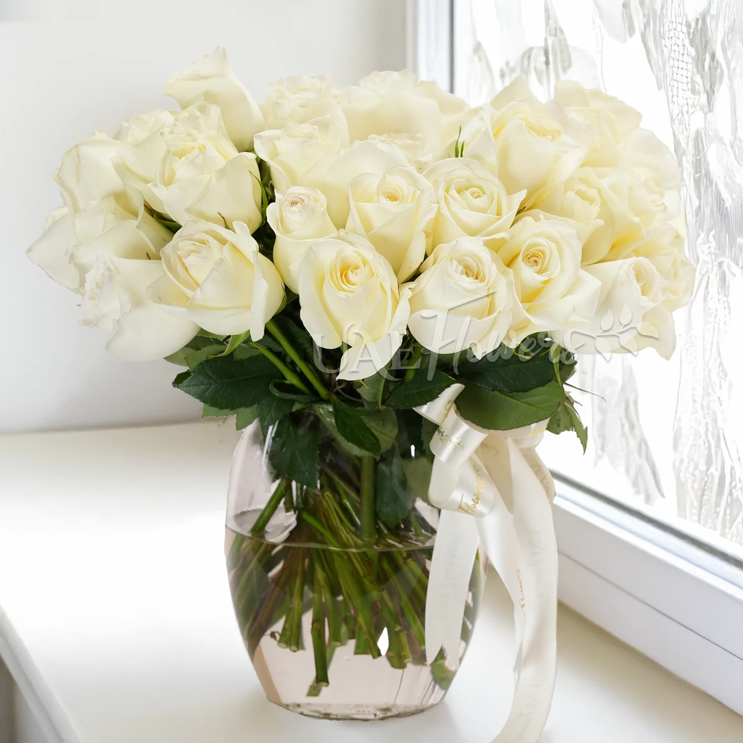 White roses, glass vase