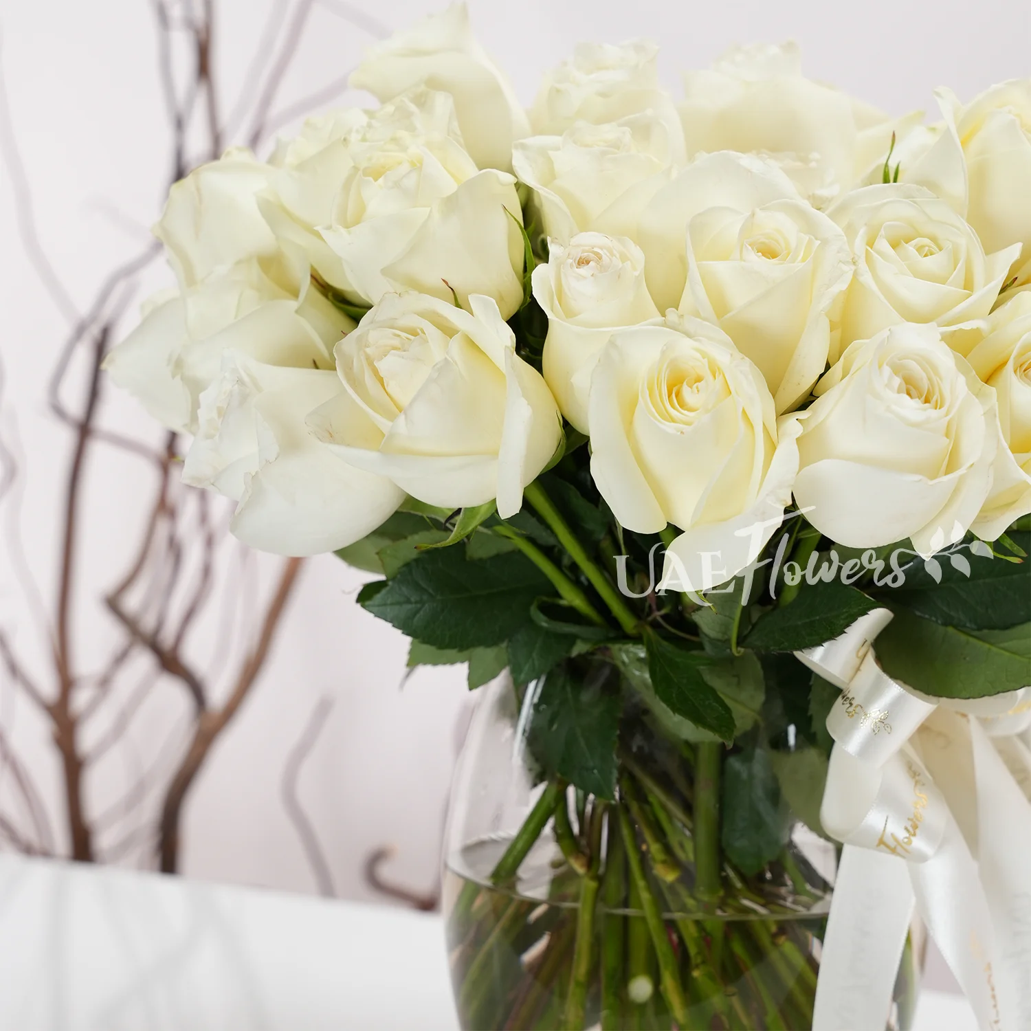 White roses, glass vase