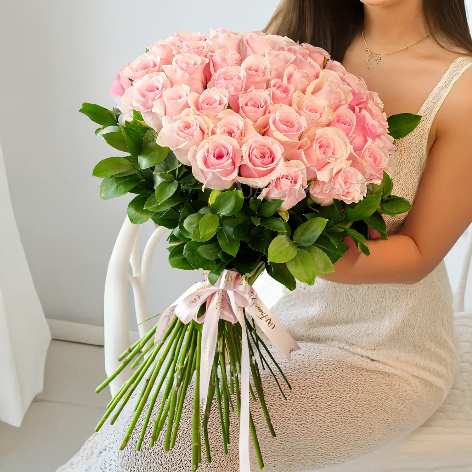 31 pink roses beautifully hand-tied with pink ribbons.