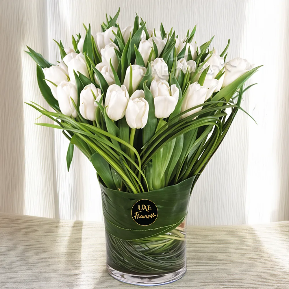 30 Stems white tulips with steel grass in a Glass Vase.