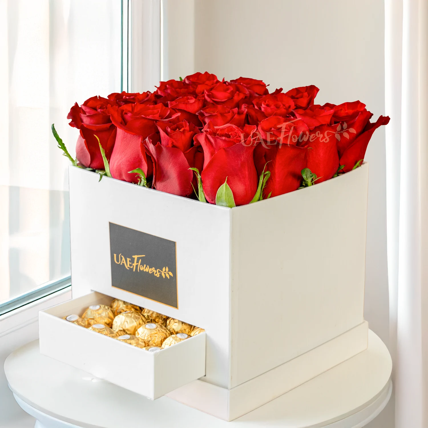 16 stems of red roses and 16 Pcs Ferrero rocher in a white box.