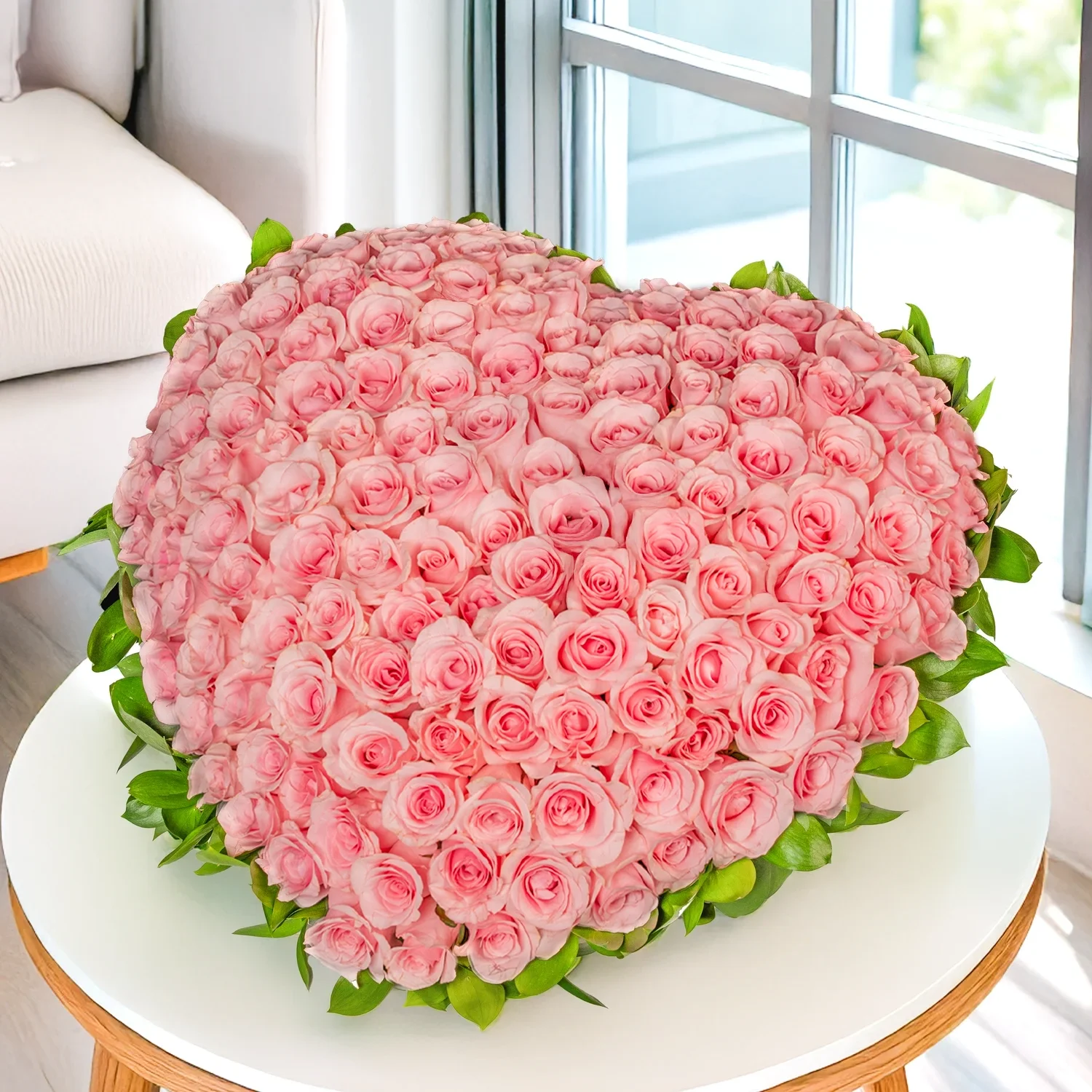 Heart-shaped arrangement of 120 pink roses with green fillers.