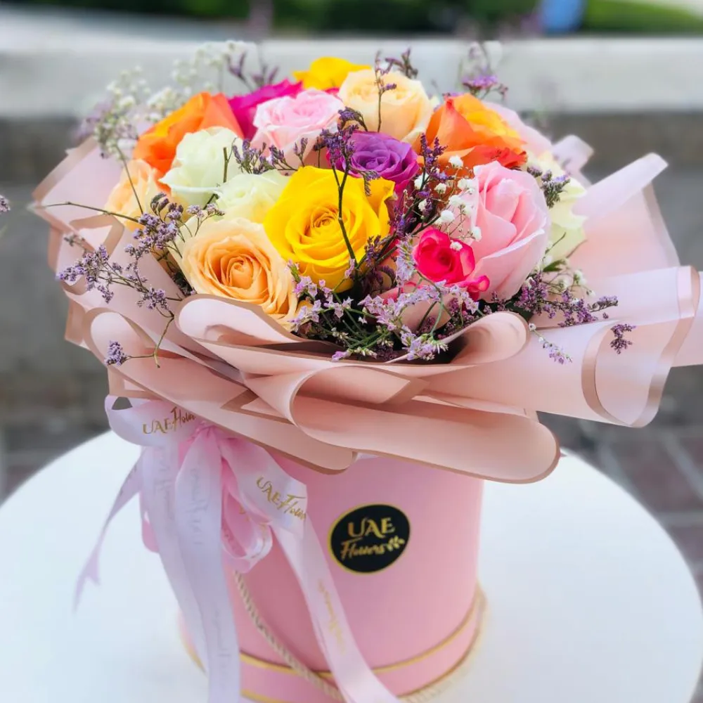 20 stems of mix color roses with fillers in a round box.