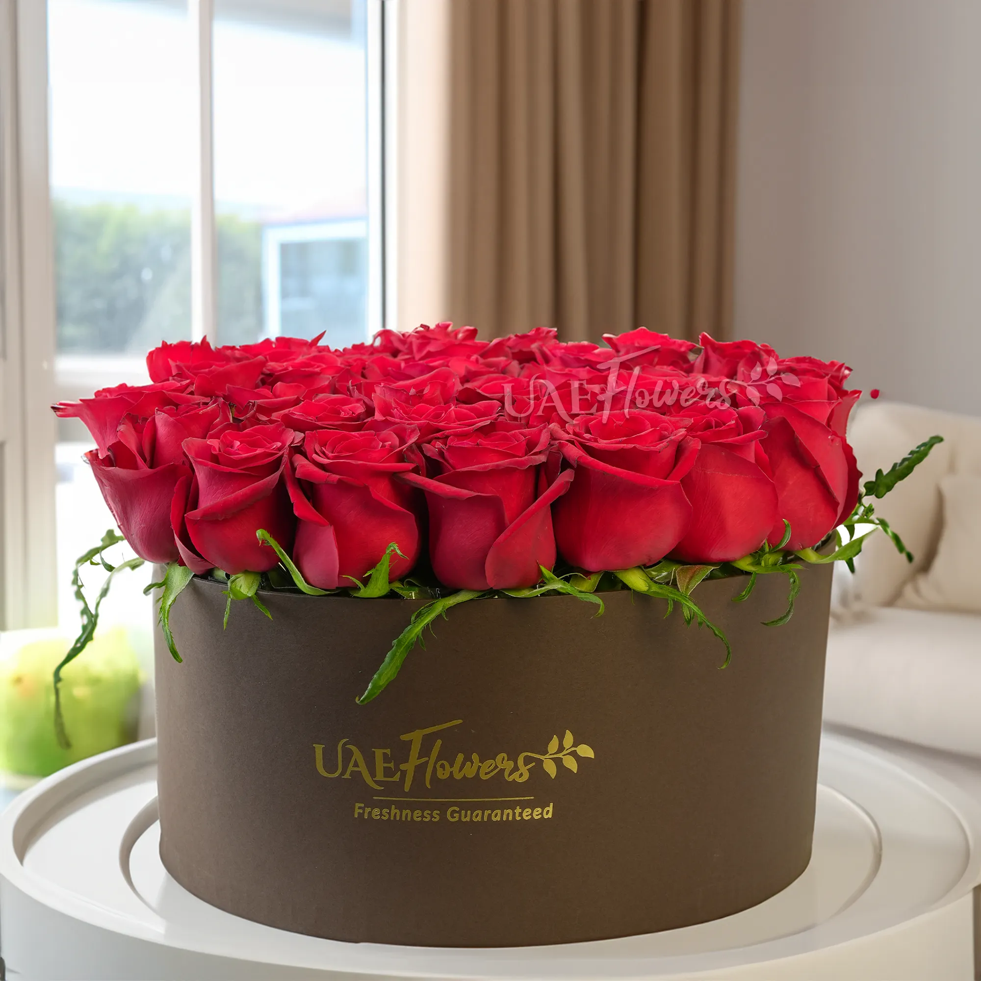 30 red roses with fillers in a round box.