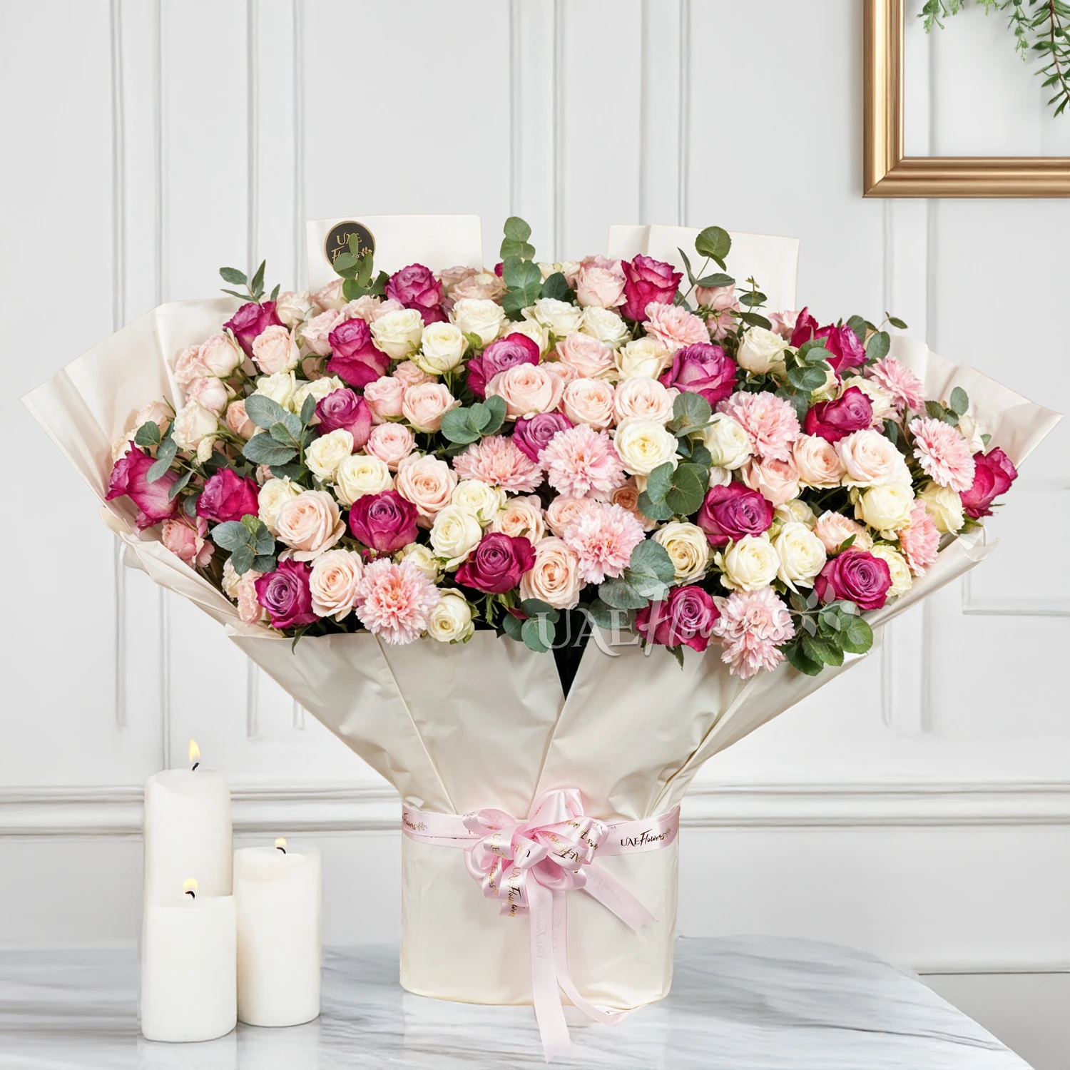 Bouquet of 30 Pink and white spray roses, 10 pink carnations and 20 purple roses with green fillers and tied with ribbons.
