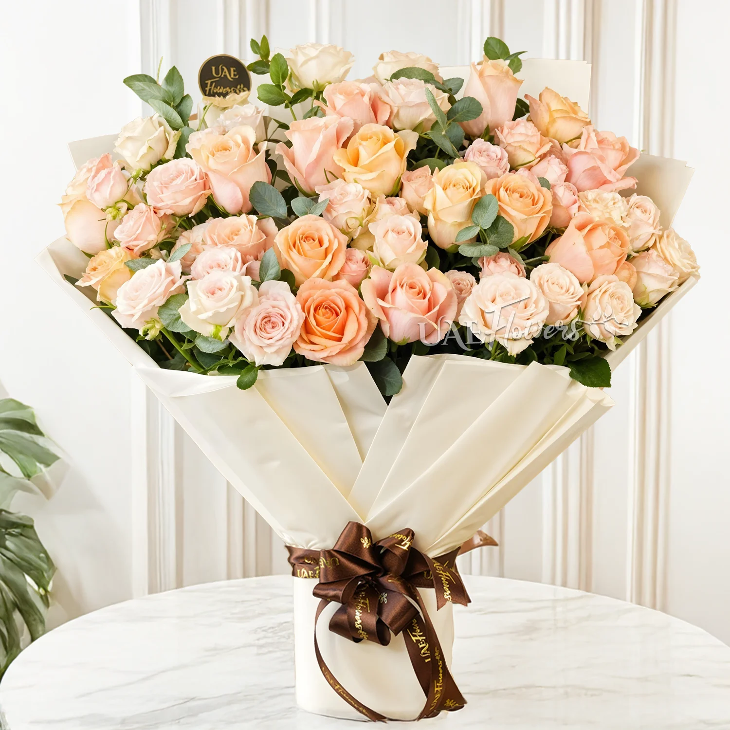Bouquet of 6 pink spray roses and 20 mixed pastel colour roses with green fillers tied with ribbons.