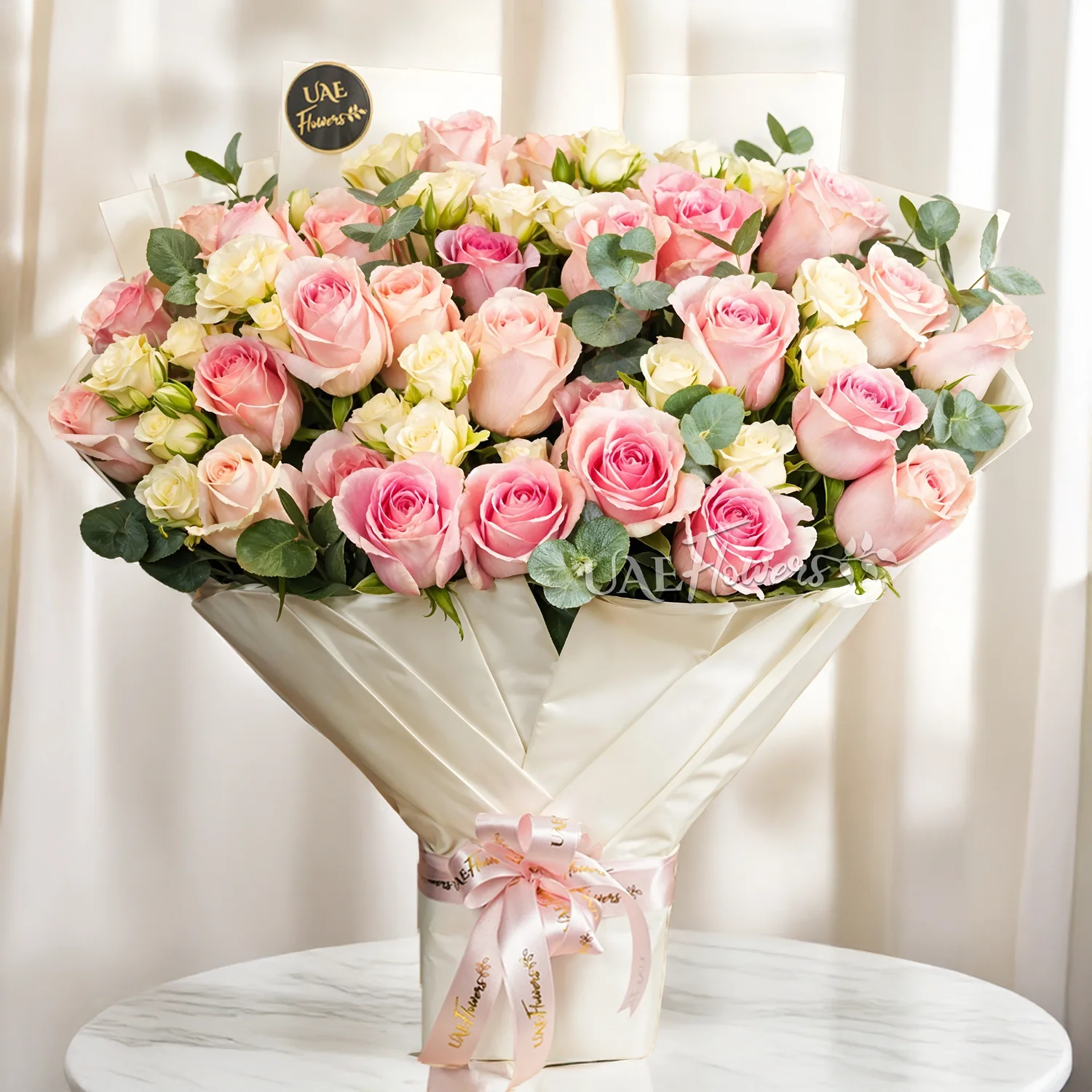 Bouquet of 10 white spray roses and 30 pink roses with green fillers tied with ribbons.