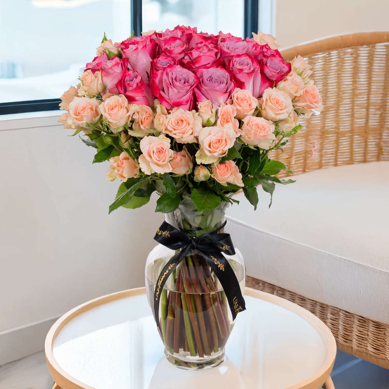 purple roses, peach spray roses, glass vase