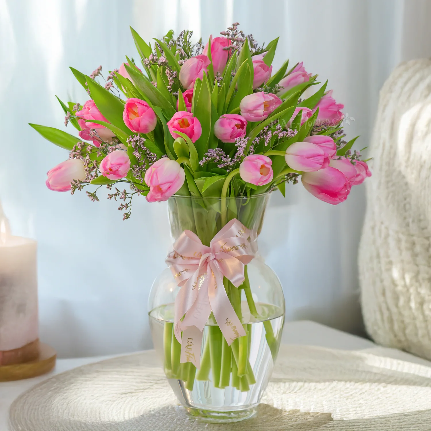20 Pink Tulips Vase Arrangement with Limonium and a pink ribbon.