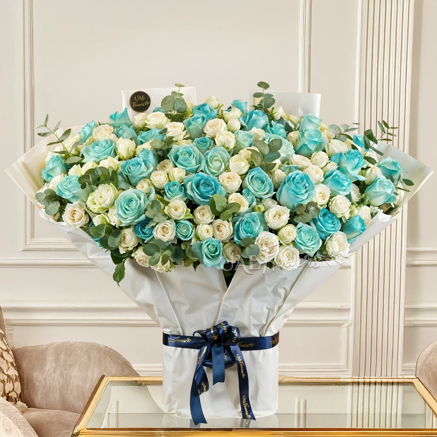 Bouquet of 20 white spray roses and 30 blue sprayed roses with green fillers tied with ribbons.