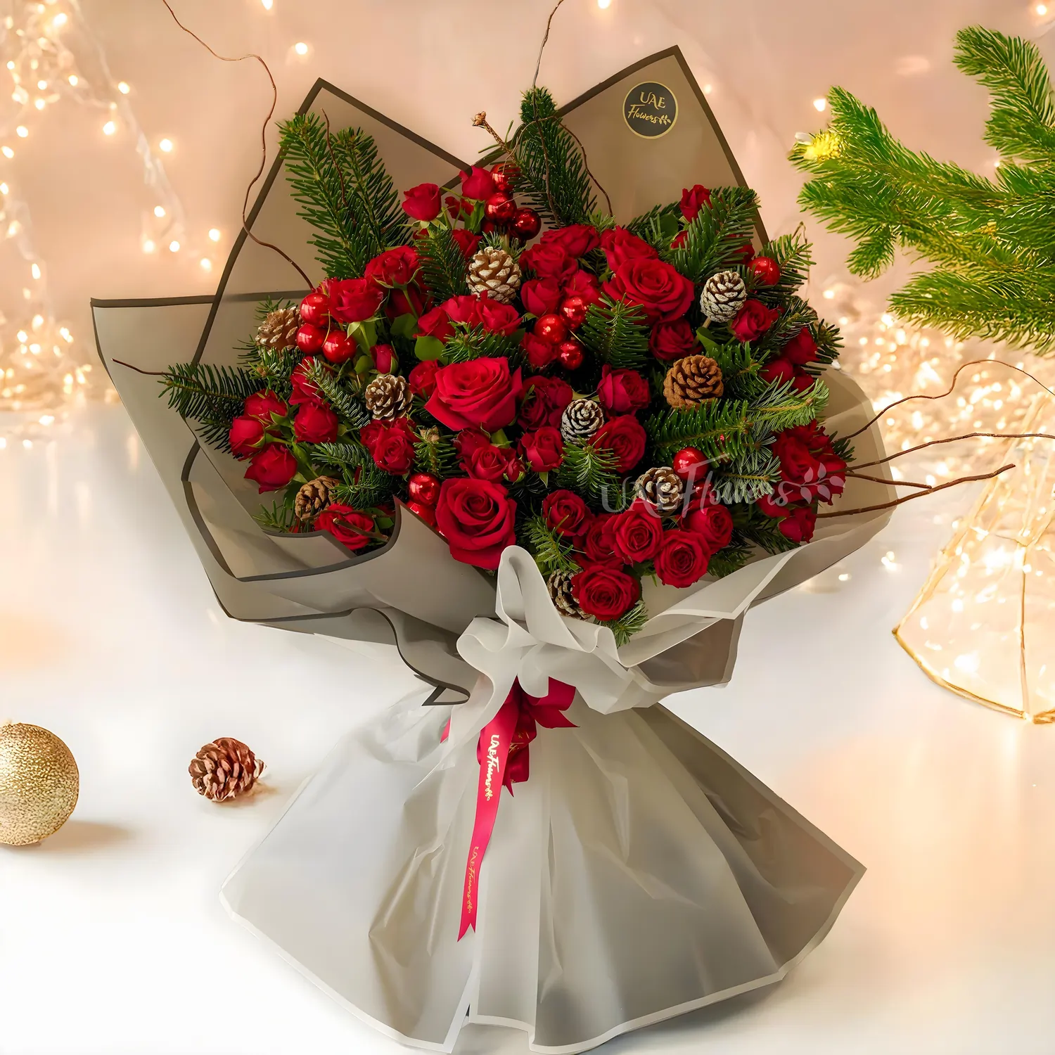 Bouquet of 3 red roses, 7 red spray roses, and Pinecones with pine leaves.