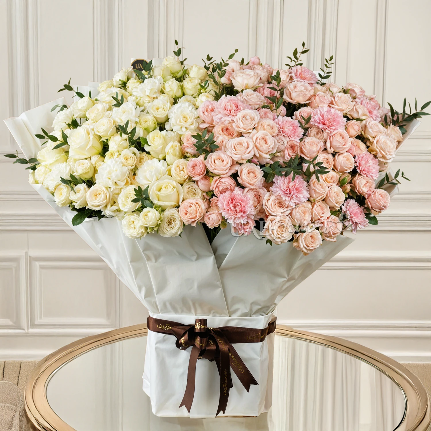 Bouquet of 20 white spray roses, 20 pink spray roses, 10 pink carnations, 10 white roses and 10 white carnations with green fillers tied with ribbons.